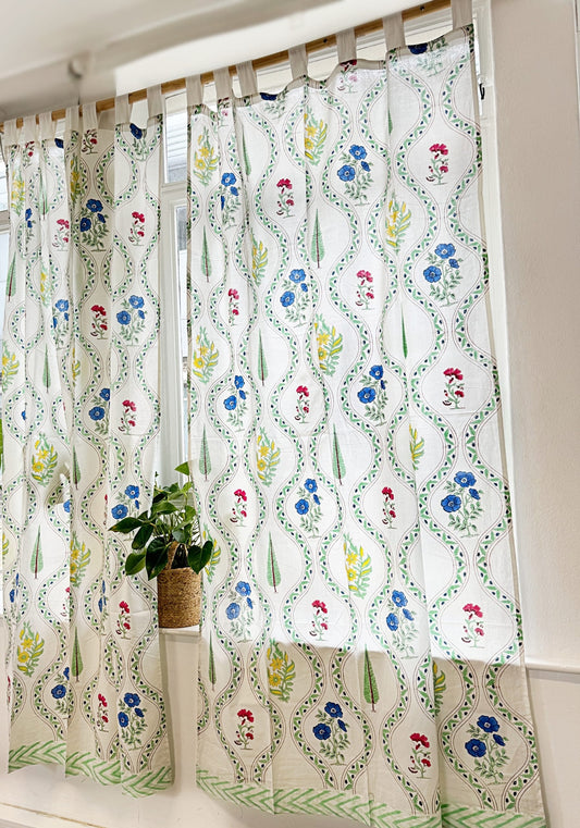 Stunning block-printed curtains on a crisp white cotton base with floral blue red